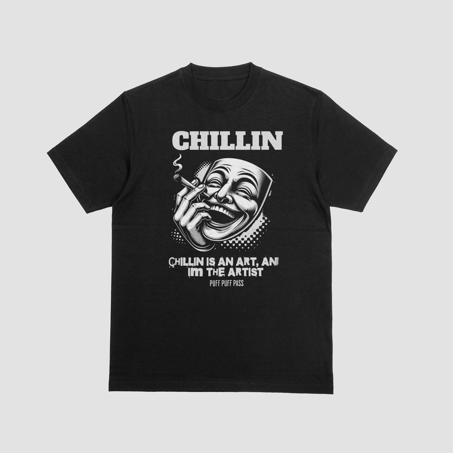 Black t-shirt with white illustration of a mask with text 'Chillin is an art, I'm the artist' on a black background.