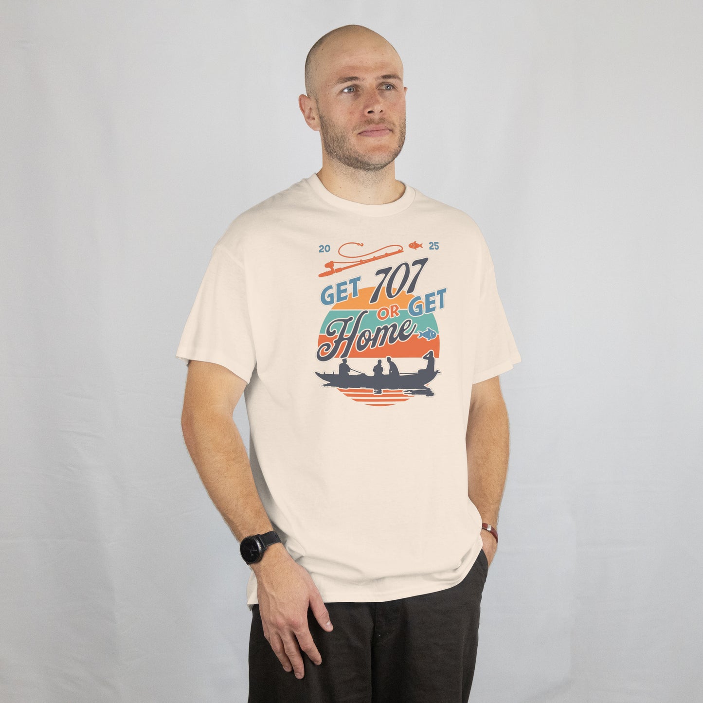 Man wearing a white t-shirt with Motivational graphic with 'Get 707 or Get Home' text and silhouette of people in a boat.