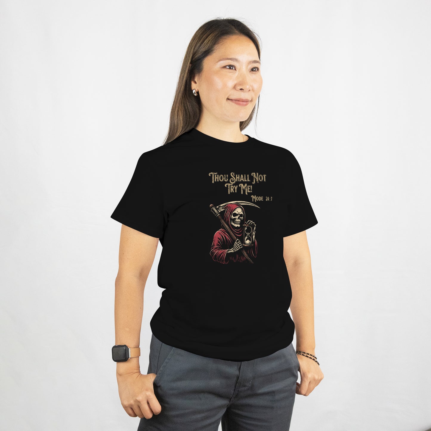 Person wearing a black t-shirt with a Grim Reaper holding a hourglass with text 'Thou Shall Not Try Me! Mode 24:7' on a white background. The model is standing against a plain background