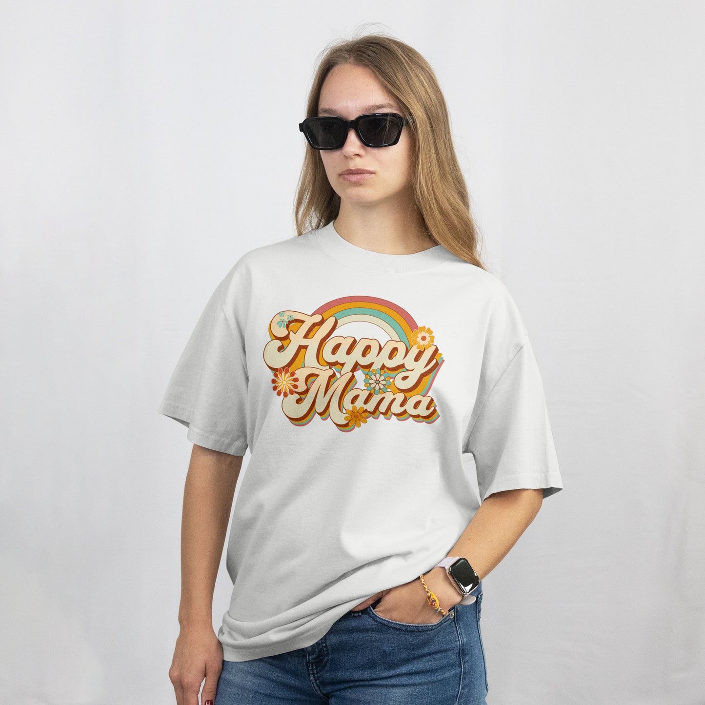 Person wearing a white t-shirt with 'Happy Mama' design on a plain background