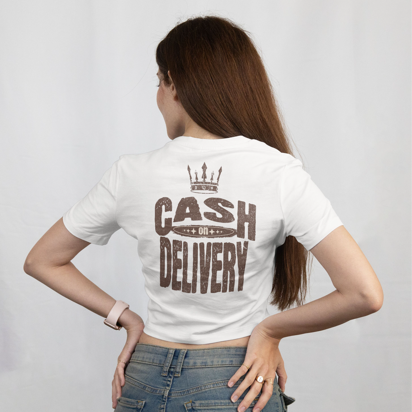 Person wearing a white t-shirt with 'Cash on Delivery' text on the back, standing against a plain background.