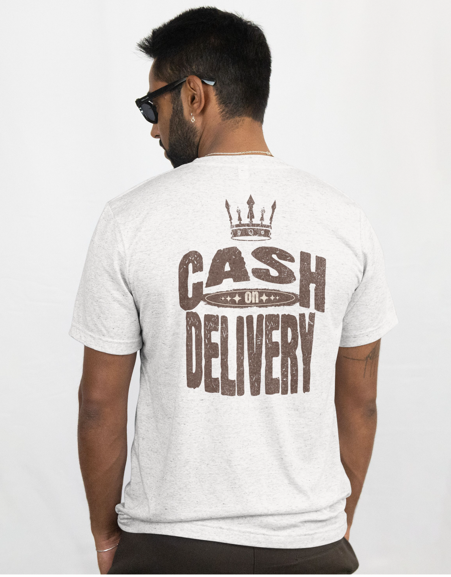 Man wearing a white t-shirt with 'Cash on Delivery' text on the back against a white background