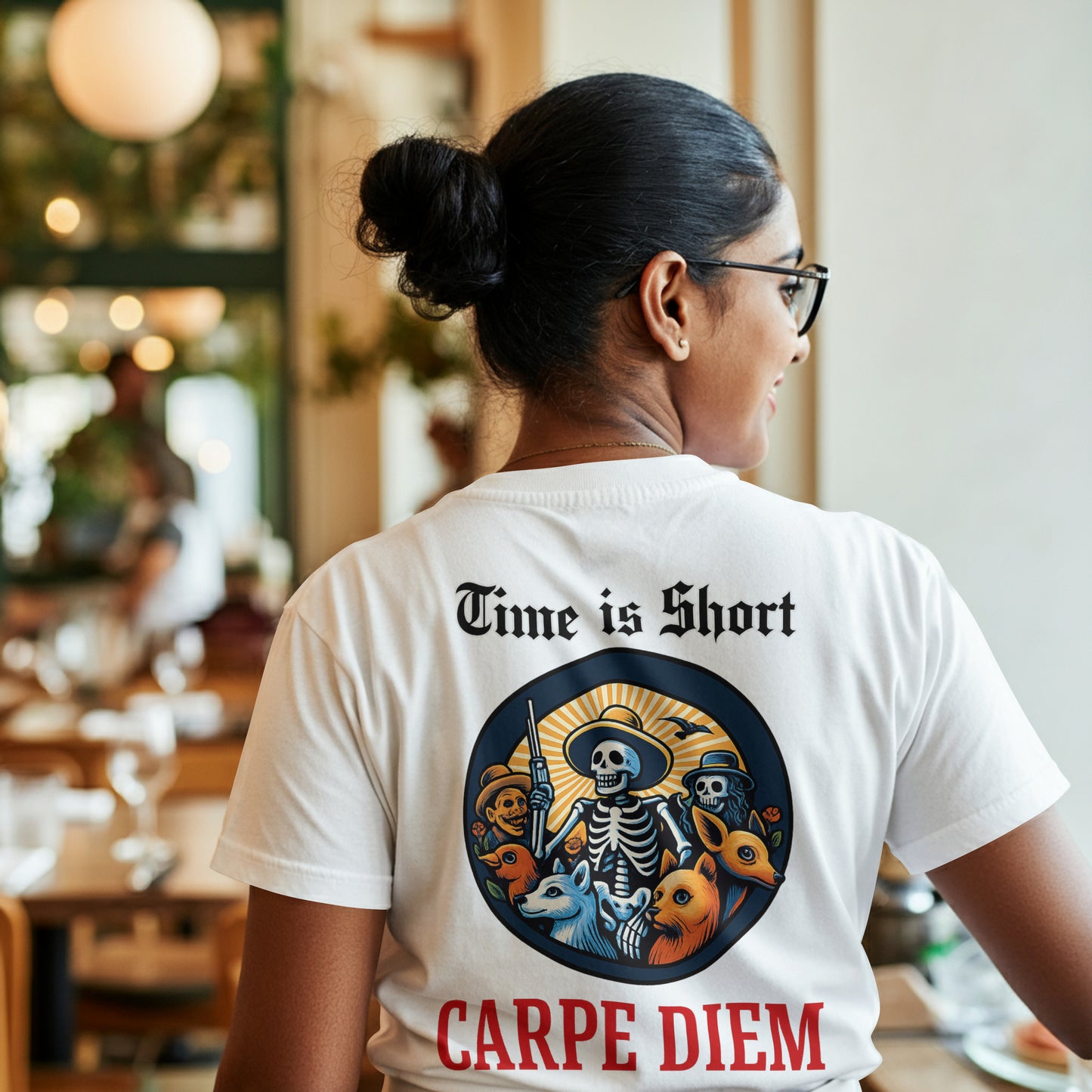 Person wearing a white t-shirt with a Circular design with skeletons, animals, and text 'Time is Short Carpe Diem' on a white background in a casual setting.