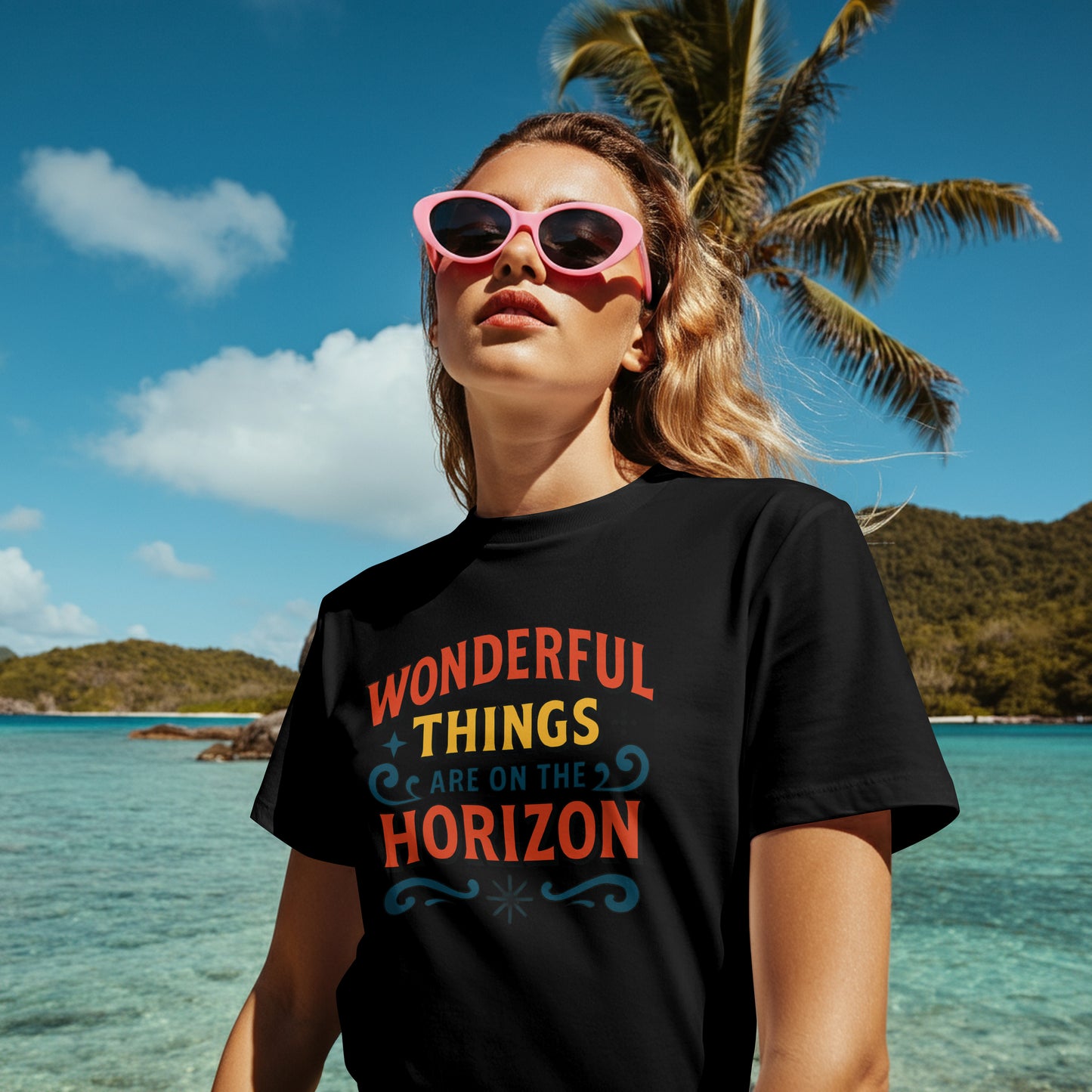 Person wearing a black t-shirt with 'Wonderful things are on the horizon' text at a tropical location.