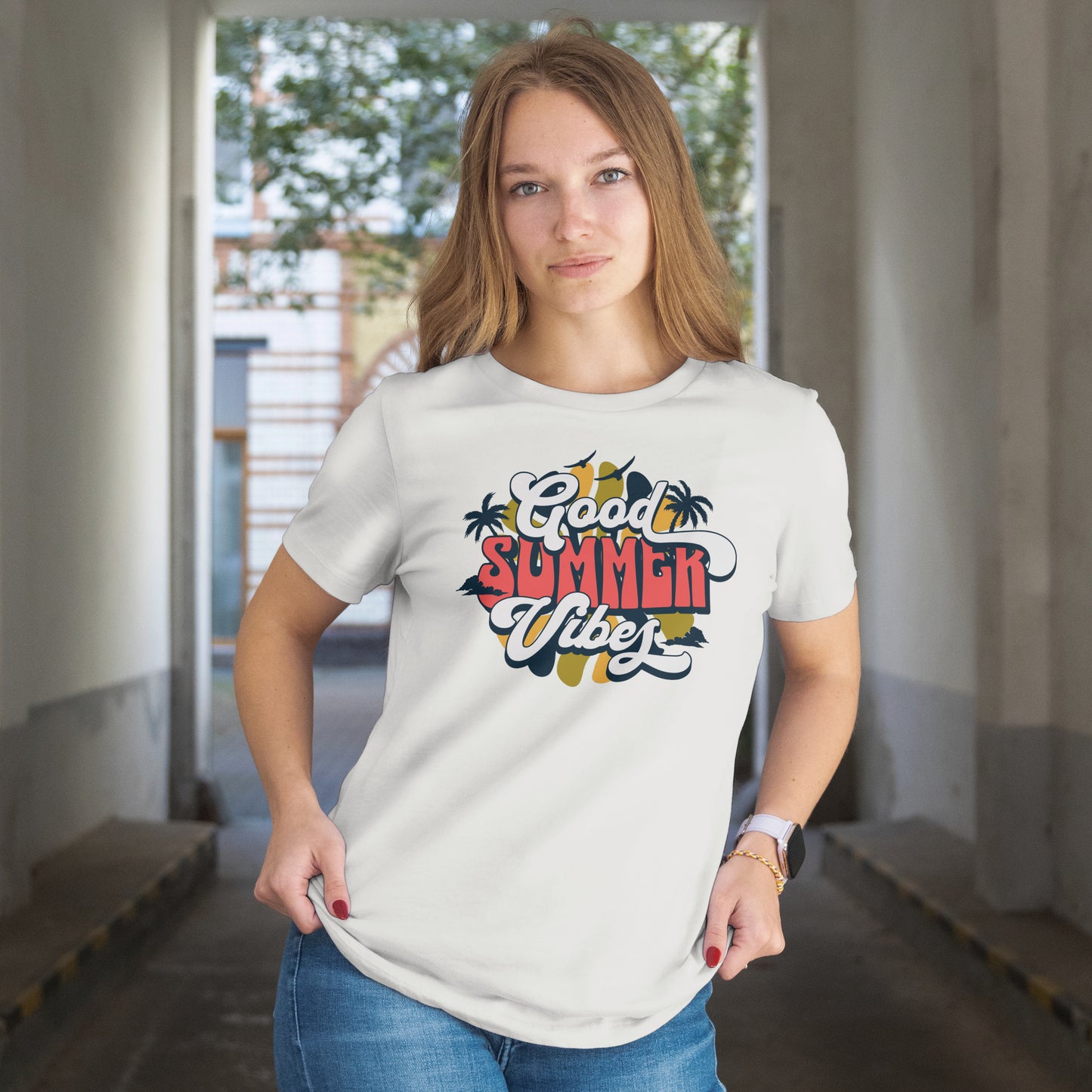 Woman wearing a white t-shirt with 'Good Summer Vibe' design in an indoor setting.