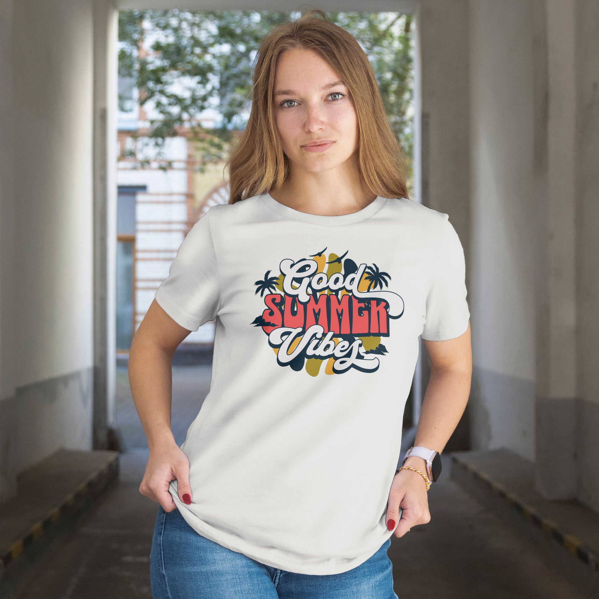 Woman wearing a white t-shirt with 'Good Summer Vibe' design in an indoor setting.
