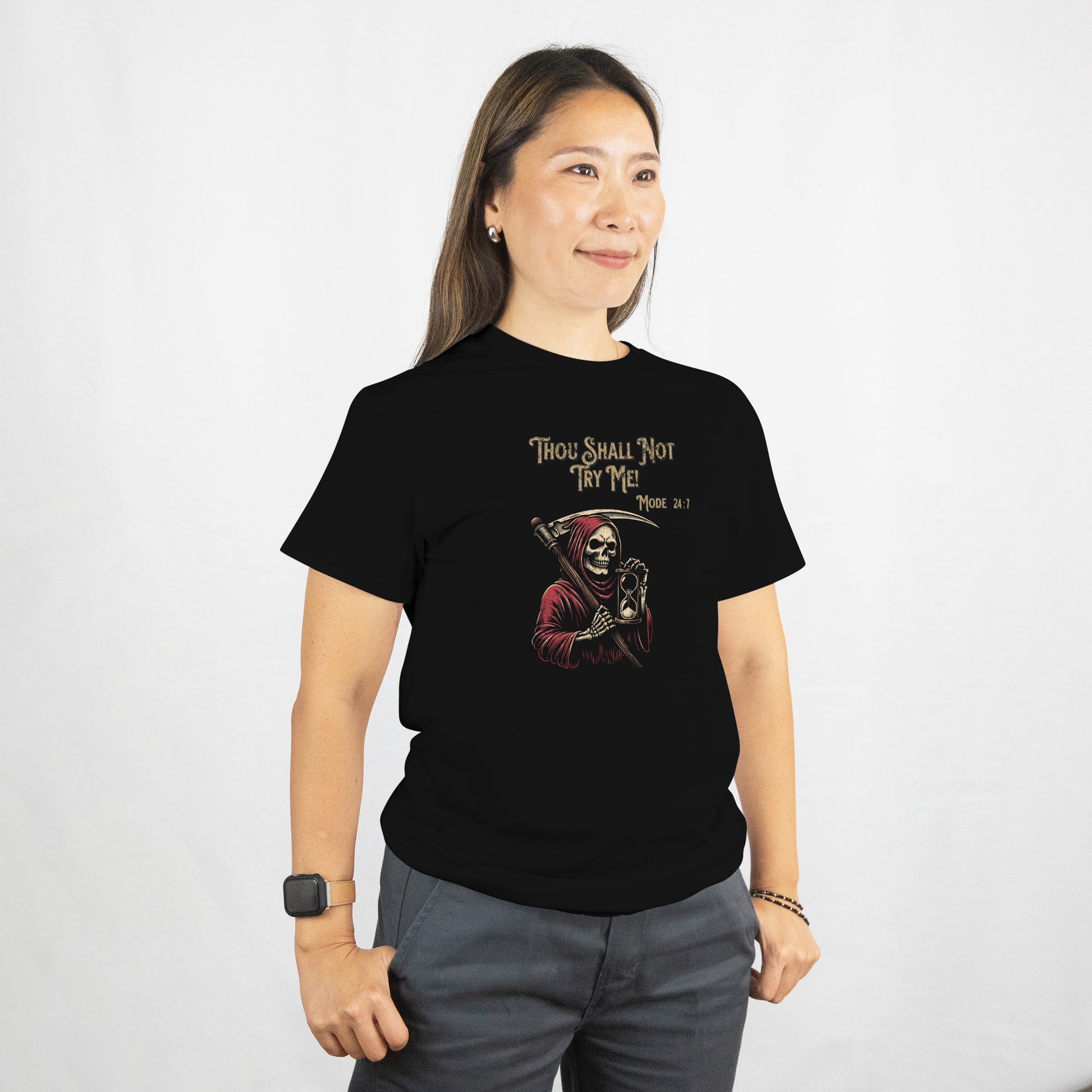 Person wearing a black t-shirt with a Grim Reaper holding a hourglass with text 'Thou Shall Not Try Me! Mode 24:7' on a white background. The model is standing against a plain background