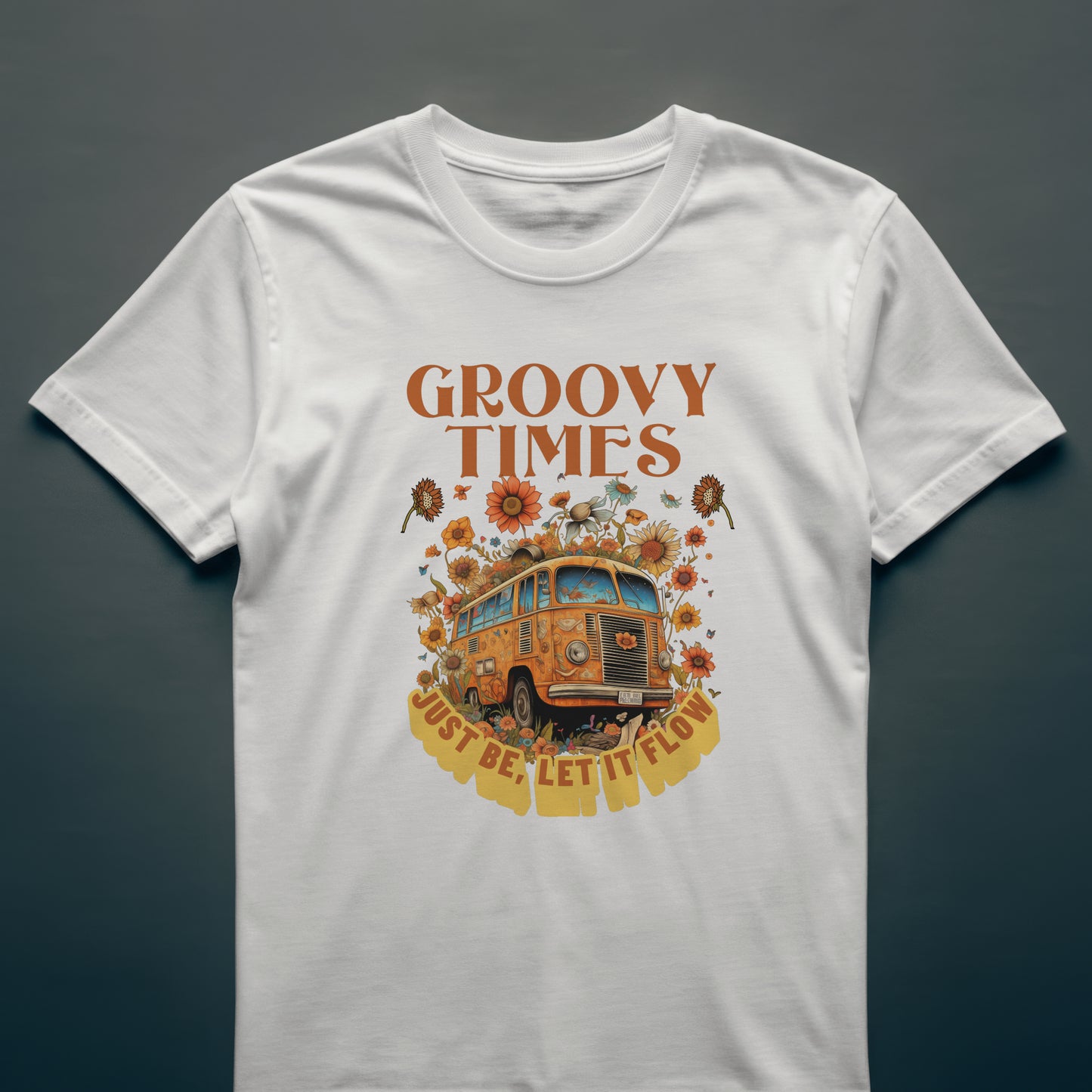 White t-shirt with a vintage bus surrounded by flowers with 'Groovy Times Just Be, Let It Flow' text on a white background.