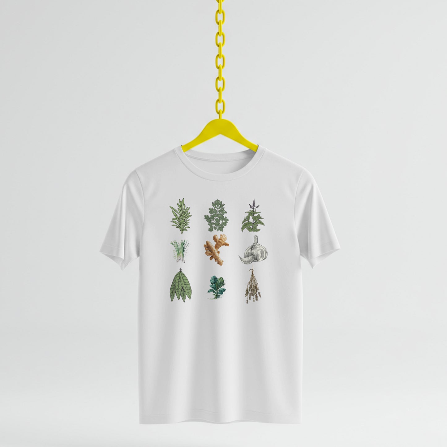 White t-shirt with Illustrations of various herbs and spices on a white background on a yellow hanger against a white background