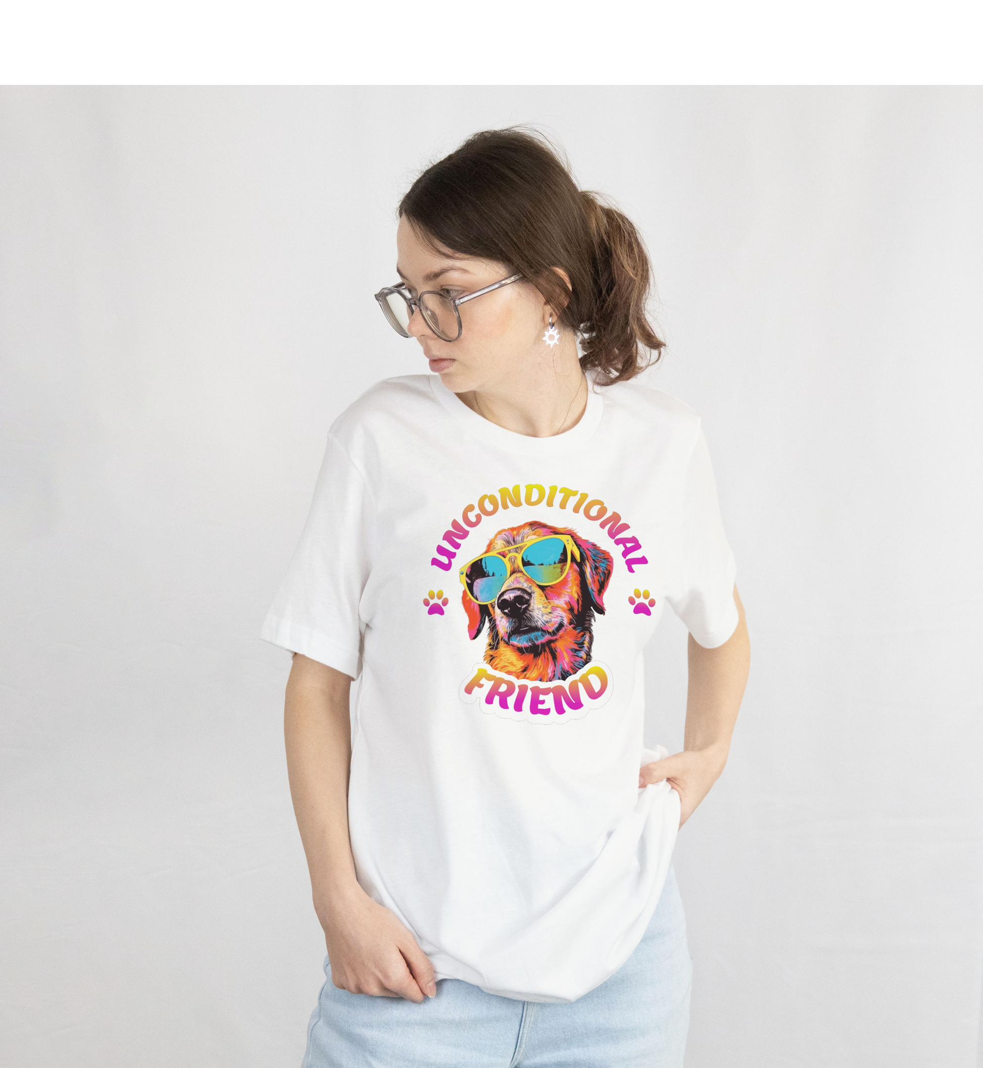 Person wearing a white t-shirt with a Colorful dog wearing sunglasses with 'Unconditional Friend' text on a white background.