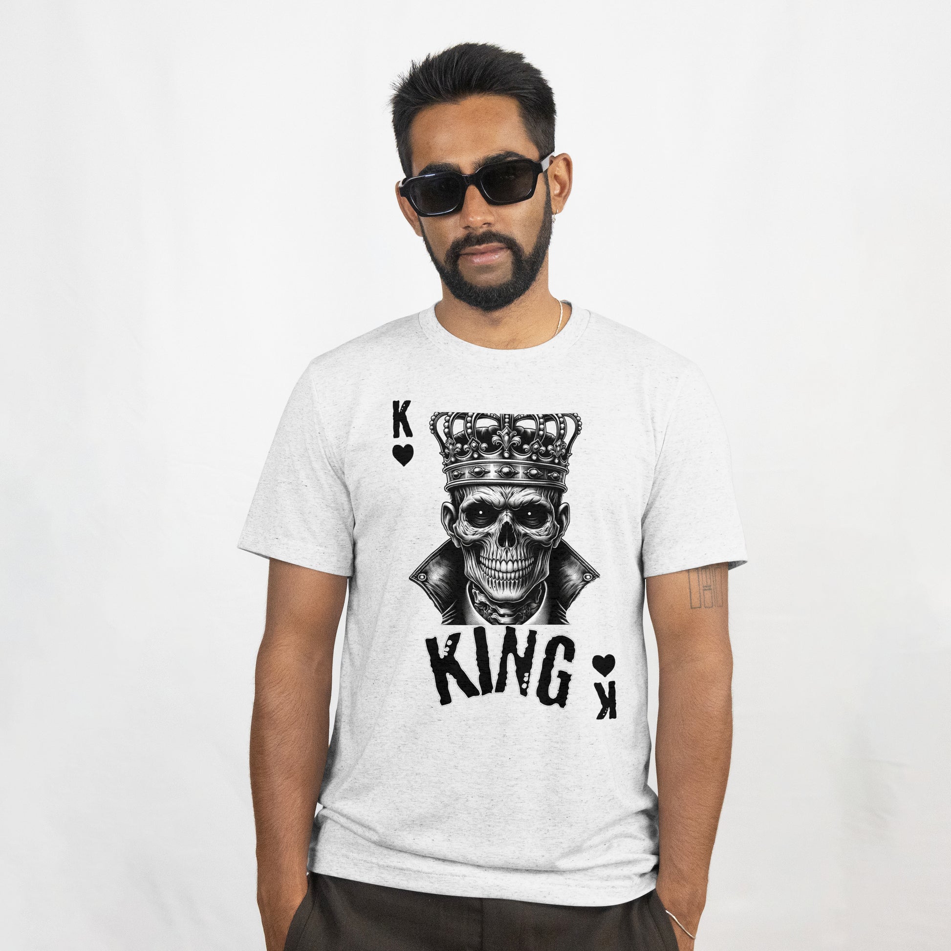 Man wearing a white t-shirt with a Skull wearing a crown with 'KING' text and playing card symbols on a white background